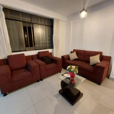 a living room with two brown couches and a table at Full apartment independent entrance, services included in Lima