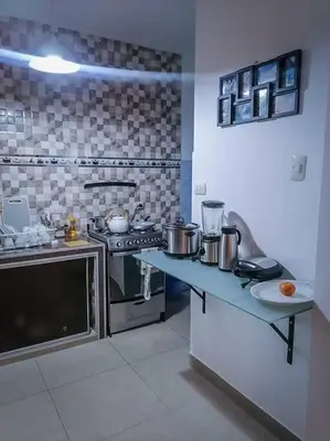 a kitchen with a stove and a counter top at Full apartment independent entrance, services included in Lima