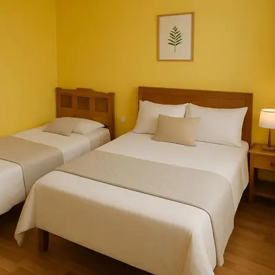 two beds in a room with yellow walls at 101 Comfy Apt WiFi kitchen SmartTV Central at Callao in Lima