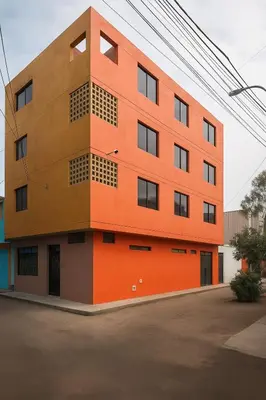 a building with an orange at 101 Comfy Apt WiFi kitchen SmartTV Central at Callao in Lima
