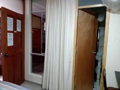 a room with a door and a window with a curtain at Estancia Saraja in Ica