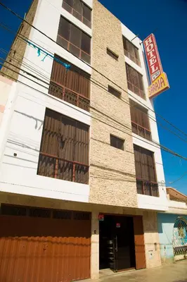 a tall building with a sign in front of it at Estancia Saraja in Ica