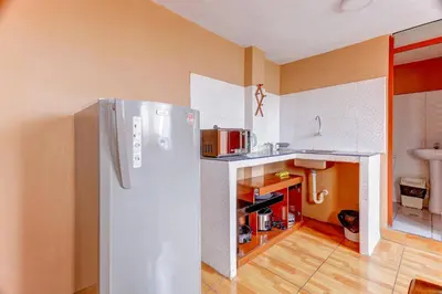 a kitchen with a white refrigerator in a room at 402 Comfy Apt WiFi kitchen SmartTV Central at Callao in Lima