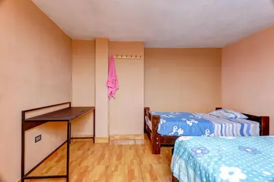 a room with two beds and a desk in it at 402 Comfy Apt WiFi kitchen SmartTV Central at Callao in Lima