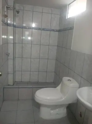 a bathroom with a toilet and a shower and a sink at 301 Comfy Apt WiFi kitchen SmartTV Central at Callao in Lima