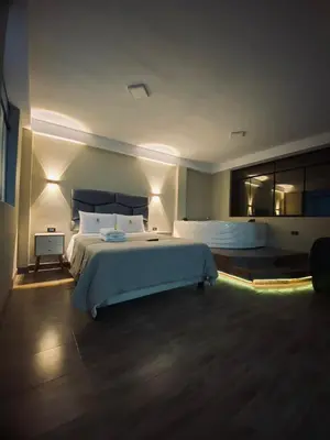 a large bedroom with a large bed and a window at HOTEL MAR Y LAGO in Lunahuaná