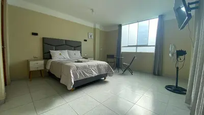 a bedroom with a bed and a large window at HOTEL MAR Y LAGO in Lunahuaná