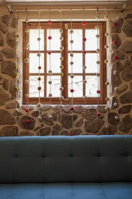 a living room with a window with christmas ornaments at Doña Catta Casa Boutique in Ollantaytambo