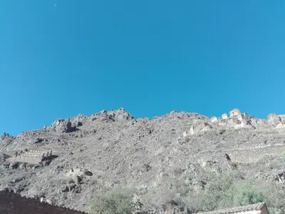 a rocky mountain with a blue sky in the background at B&B Chayana Wasi in Ollantaytambo