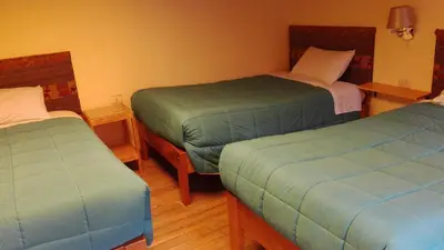 a room with two twin beds in a room at B&B Chayana Wasi in Ollantaytambo