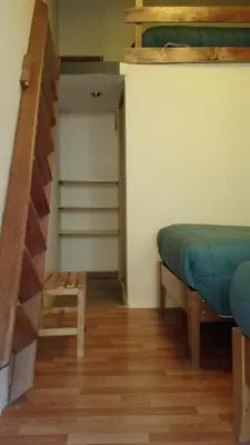 a bedroom with a bunk bed and a stair case at B&B Chayana Wasi in Ollantaytambo