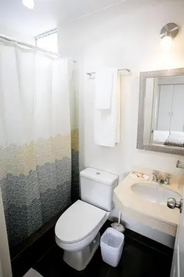 a bathroom with a white toilet and a sink at Miraflores - Luxury Room in the Best Place in Lima