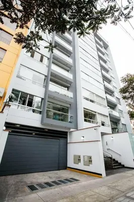 a large building with a garage in front of it at Miraflores - Luxury Room in the Best Place in Lima