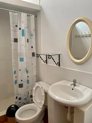 a bathroom with a sink and a toilet and a mirror at Las Cabañas de Incahuasi in Lunahuaná