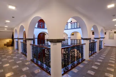 a hallway of a building with arches at Hotel Hacienda Cusco Centro Historico in Cusco