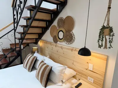 a bedroom with a bed with a wooden headboard at CASA CRISTOBAL Siete Cuartones in Cusco