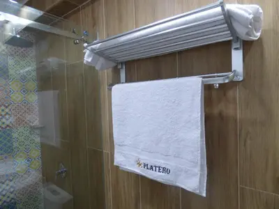 a towel hanging on a wall in a bathroom at Platero Hotel in Ayacucho
