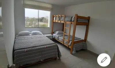 a bedroom with two bunk beds and a window at Depa de Playa en Asia in Asia