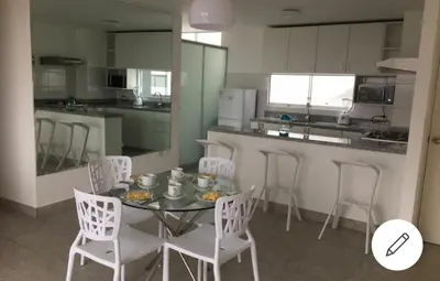 a kitchen with a table and chairs and a counter at Depa de Playa en Asia in Asia