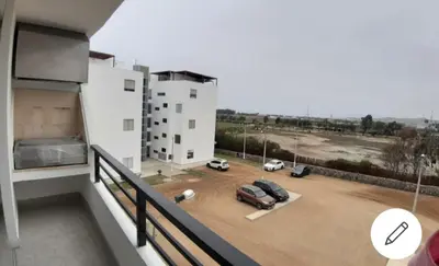 a balcony with cars parked in a parking lot at Depa de Playa en Asia in Asia