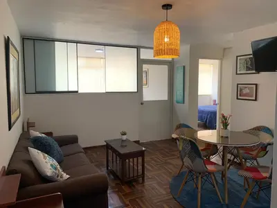 a living room with a couch and a table at Lindo departamento en Magdalena del Mar in Lima