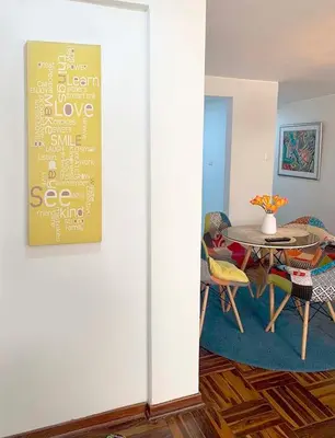 a dining room with a table and a table and a dining room at Lindo departamento en Magdalena del Mar in Lima