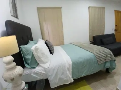 a bedroom with a bed and a chair at Central, cozy & self-contained petfriendly apartments in the heart of Miraflores in Lima