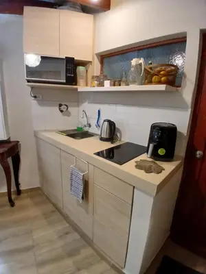 a small kitchen with a sink and a microwave at Central, cozy & self-contained petfriendly apartments in the heart of Miraflores in Lima