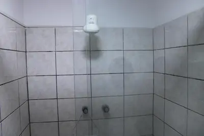 a bathroom with a shower with a light on the ceiling at Hospedaje San Isidro 402 in Lima
