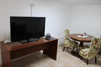 a room with a television and a table with chairs at Hospedaje San Isidro in Lima