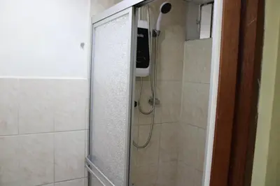 a shower with a glass door in a bathroom at Hospedaje San Isidro in Lima