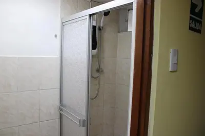 a shower with a glass door in a bathroom at Hospedaje San Isidro in Lima