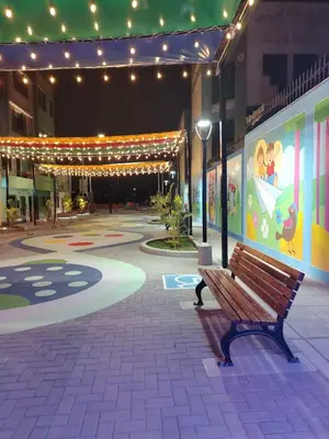a bench sitting in the middle of a building with lights at Chakana Family Home 2 Lima Airport in Lima
