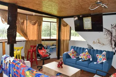 a living room with a blue couch and chairs at New Experiences Valle sagrado in Urubamba