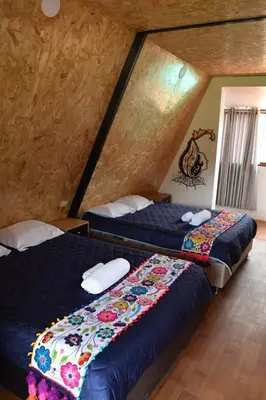 a bedroom with two beds in a attic at New Experiences Valle sagrado in Urubamba