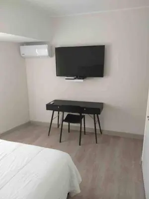 a bedroom with a desk and a flat screen tv at MLA apartments - Reducto 360 in Lima