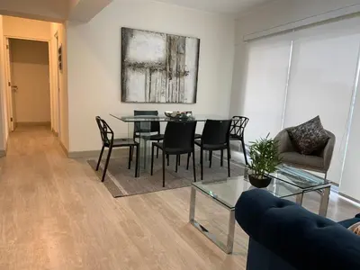 a living room with a table and chairs and a couch at MLA apartments - Reducto 360 in Lima