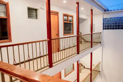 a staircase in a house with red railings at Estancia San Pedro Hotel in Cusco