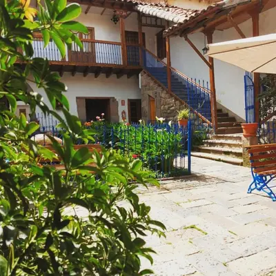 a house with blue stairs and a bench at Terra Sagrada Cusco in Cusco
