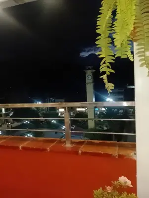 a view of a clock tower from a balcony at Chanka Suites in Talavera