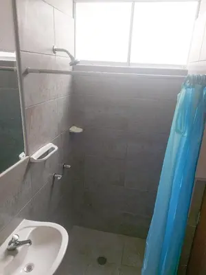 a bathroom with a sink and a shower with a shower curtain at Residencia Benavides in San Vicente de Cañete