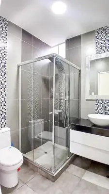 a bathroom with a shower and a toilet and a sink at Apartamento JATUN MAMA in Chancay