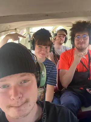 a group of people sitting in the back of a van at La Petite Maison in Nazca