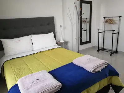a bedroom with a bed with towels on it at DEL VALLE HOUSE II in Ica