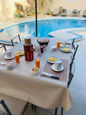 a table with food and drinks next to a pool at DEL VALLE HOUSE II in Ica