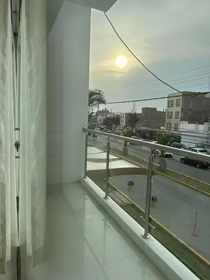 a room with a balcony with a view of a street at Hotel Overland in Paracas