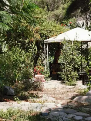 a garden with a white canopy and a bench at Villa Celestial in Nieve Nieve