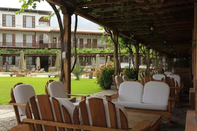 a group of chairs and tables in a pavilion at Hotel Viñas Queirolo in Ica