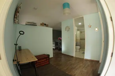 a living room with a table and a mirror at Apartamento 3 Habitaciones Lima, Perú (Magdalena del Mar) in Lima
