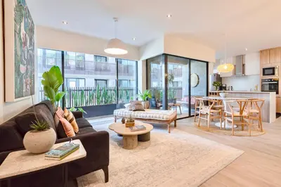 a living room with a couch and a table at ✶ Maras Residence ✶ LUXURY Rooftop Pool & Grill in Lima
